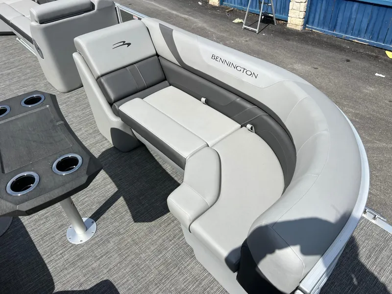 Slide: The Image of 2024 Bennington 22S boat interior with gray seating and cup holders. - 6