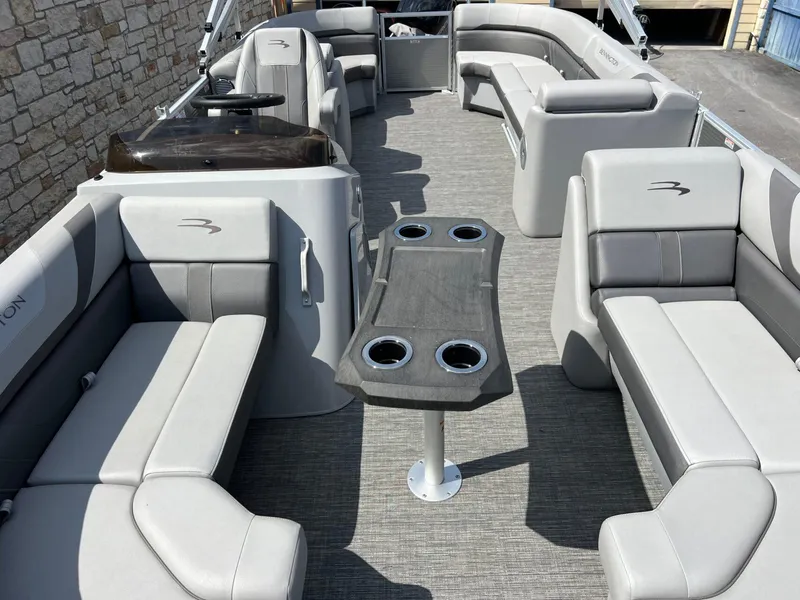Slide: The Image of 2024 Bennington 22S pontoon boat interior with gray seating and central table. - 7