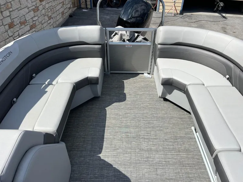 Slide: The Image of 2024 Bennington 22S pontoon boat interior with gray seating and carpeted floor. - 9