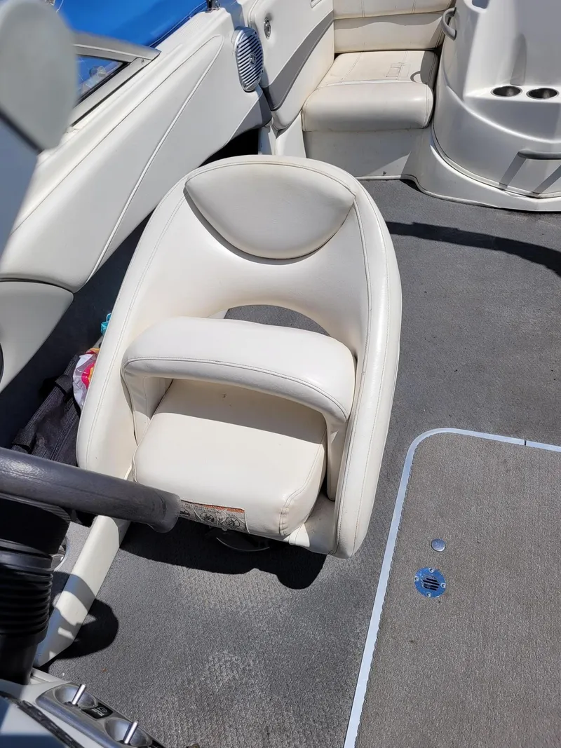 Slide: The Image of Interior of a 2008 Bayliner 205 boat with white seating and grey flooring. - 10
