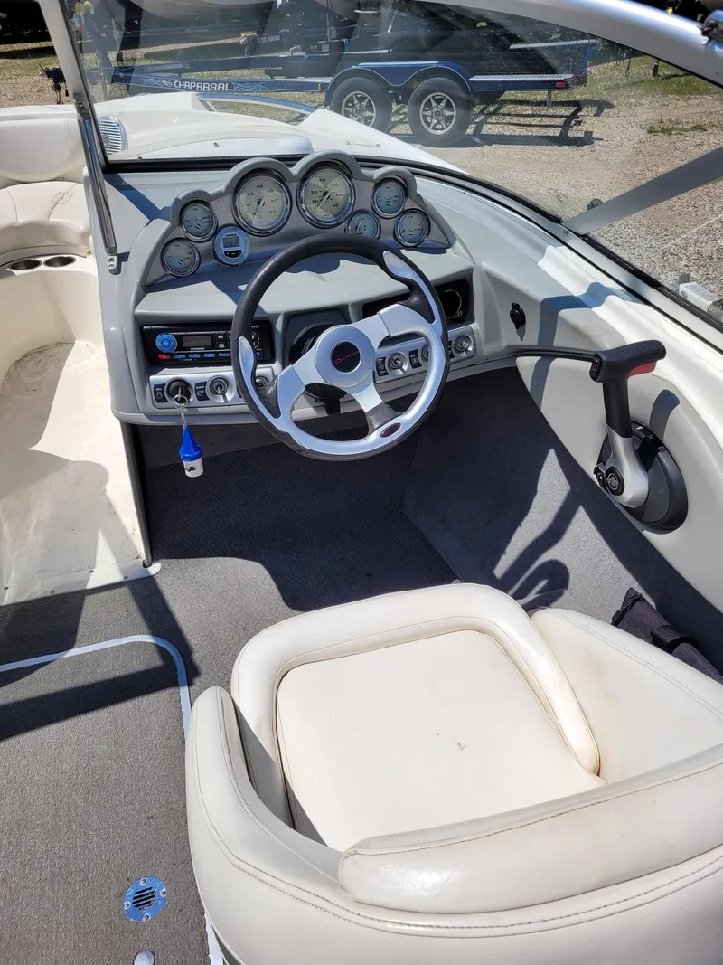 Slide: The Image of 2008 Bayliner 205 boat cockpit with steering wheel and dashboard gauges. - 11