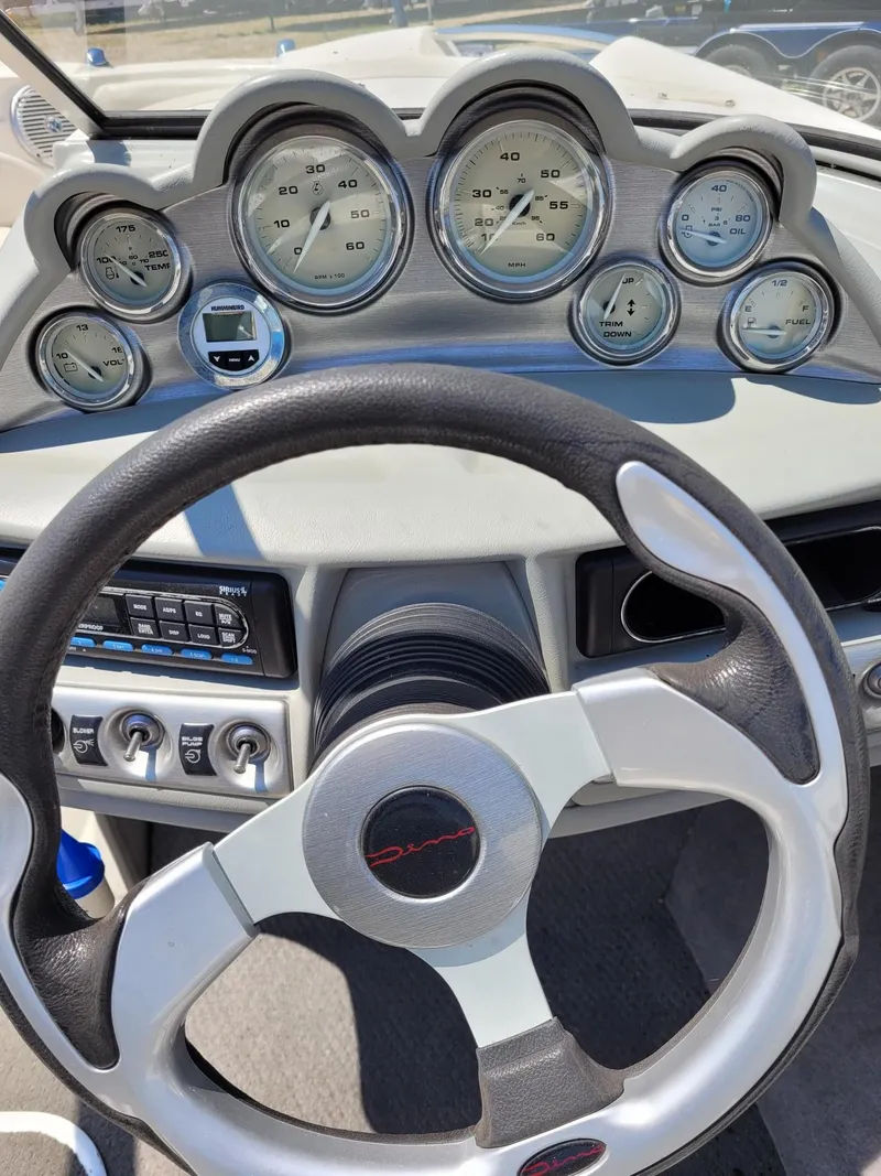 Slide: The Image of Dashboard of a 2008 Bayliner 205 boat with steering wheel and gauges. - 12