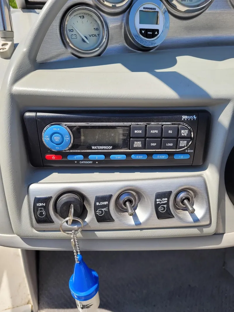 Slide: The Image of Dashboard of a 2008 Bayliner 205 boat with ignition, blower, bilge pump, and stereo controls. - 13