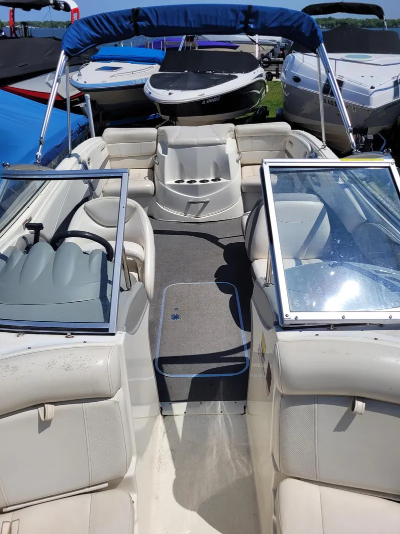 Slide: The Image of 2008 Bayliner 205 boat interior with seating and blue canopy. - 15