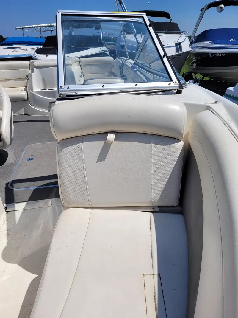 Slide: The Image of 2008 Bayliner 205 boat interior with white seating and windshield. - 16