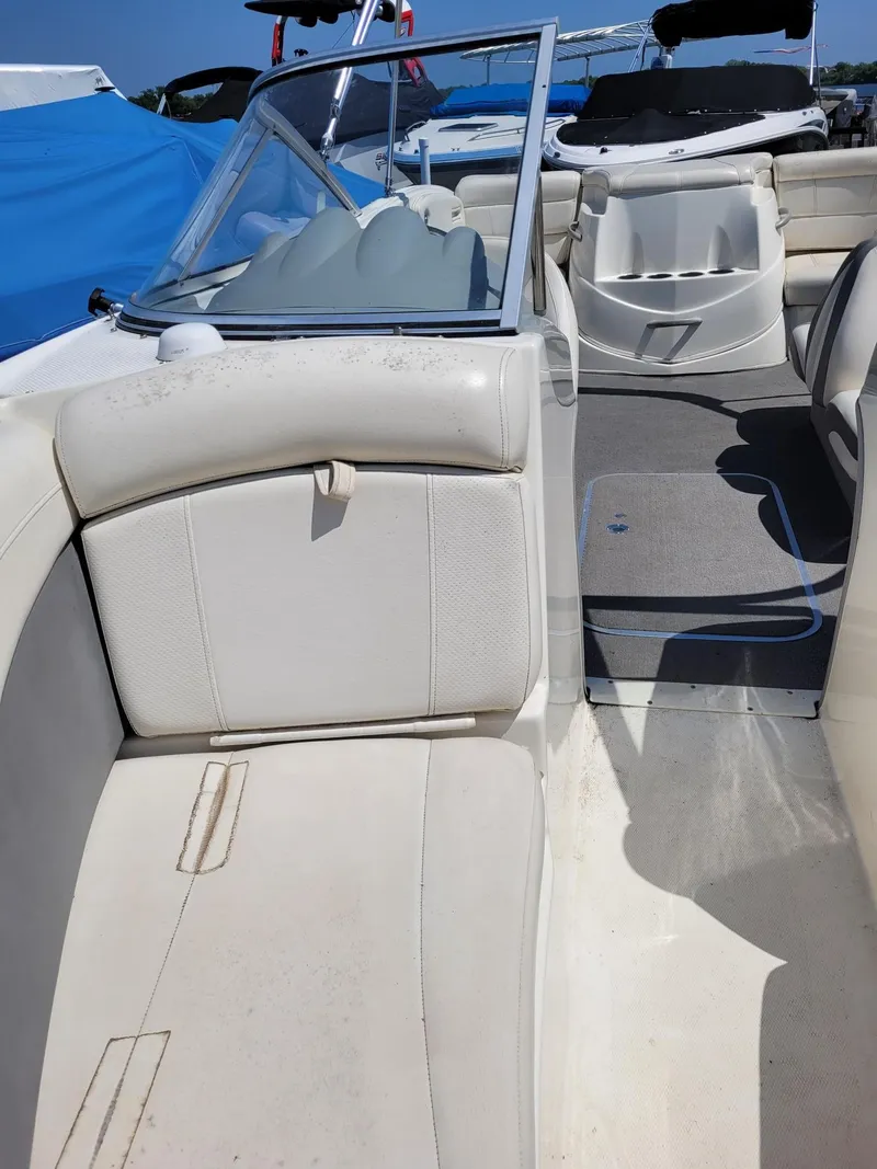Slide: The Image of Interior of a 2008 Bayliner 205 boat with white seating and windshield. - 17