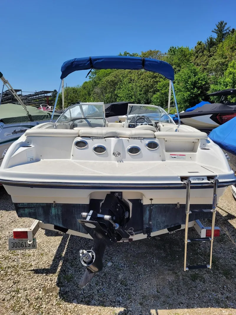 Slide: The Image of 2008 Bayliner 205 boat with blue canopy and outboard motor. - 3