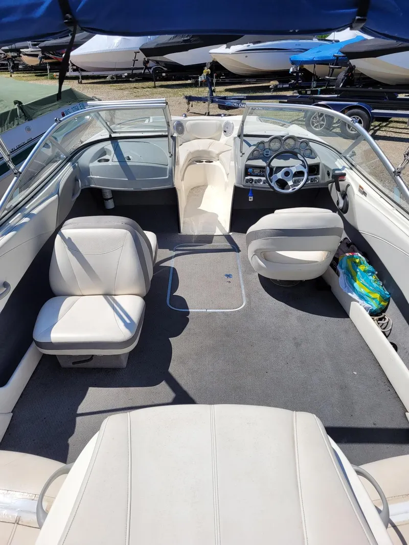 Slide: The Image of Interior of a 2008 Bayliner 205 boat with seating and steering wheel. - 5