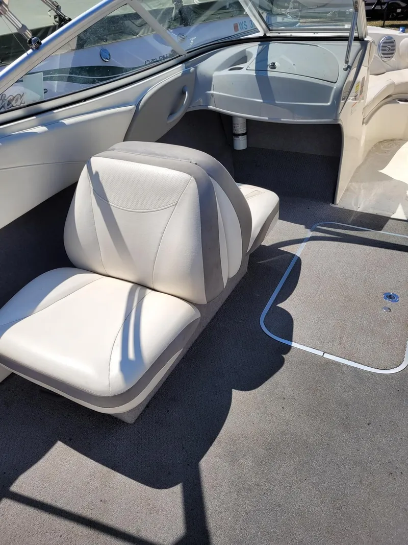 Slide: The Image of Interior of a 2008 Bayliner 205 boat with white and gray seating. - 7
