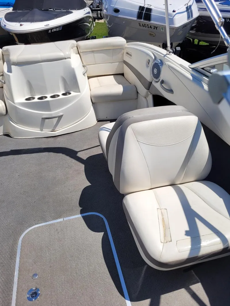 Slide: The Image of 2008 Bayliner 205 boat interior with white seating and carpeted floor. - 8