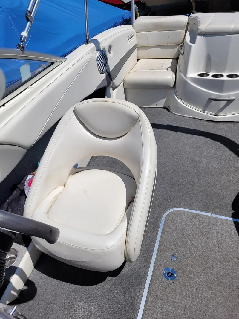 Slide: The Image of Interior of a 2008 Bayliner 205 boat with white seating and gray carpet. - 9