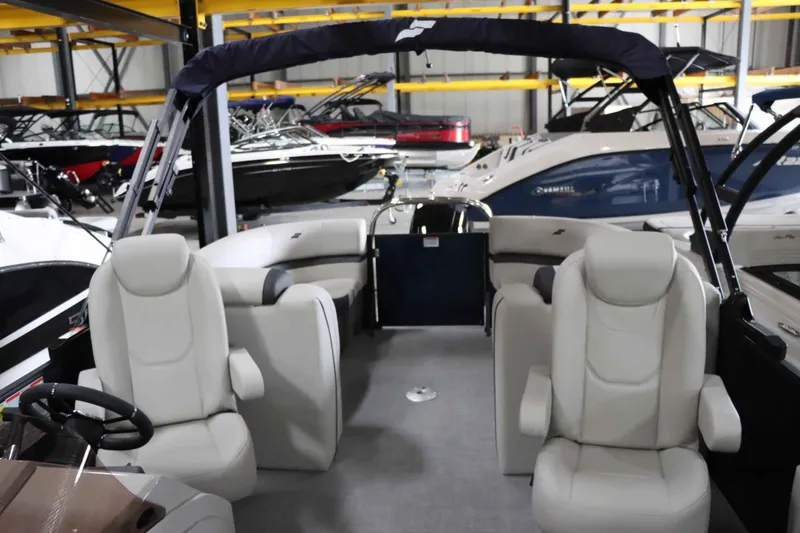 Slide: The Image of 2025 Starcraft EXS 3 boat interior with plush seating in a showroom. - 16