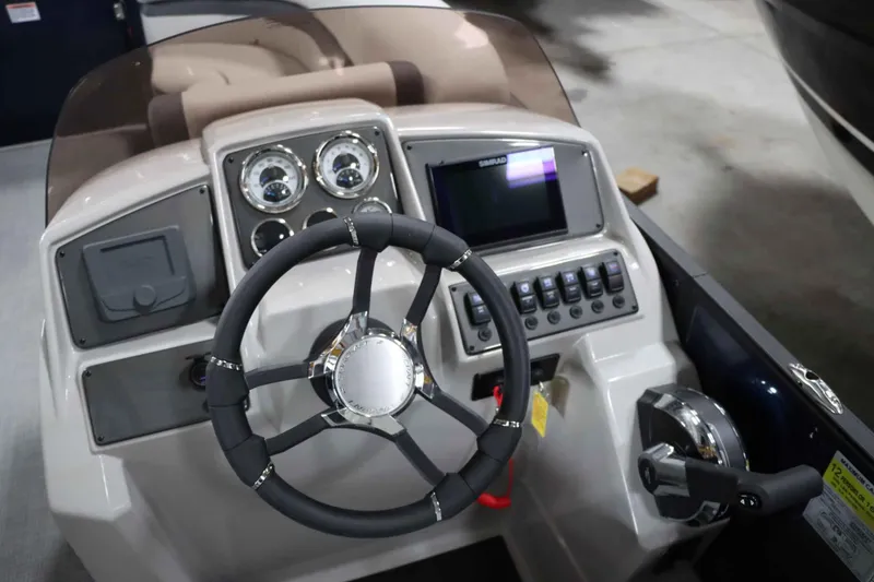 Slide: The Image of 2025 Starcraft EXS 3 boat dashboard with steering wheel and control panel. - 19