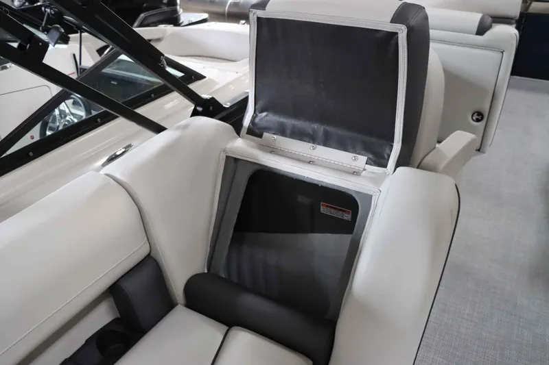 Slide: The Image of Starcraft EXS 3 2025 boat seat with storage compartment open. - 24