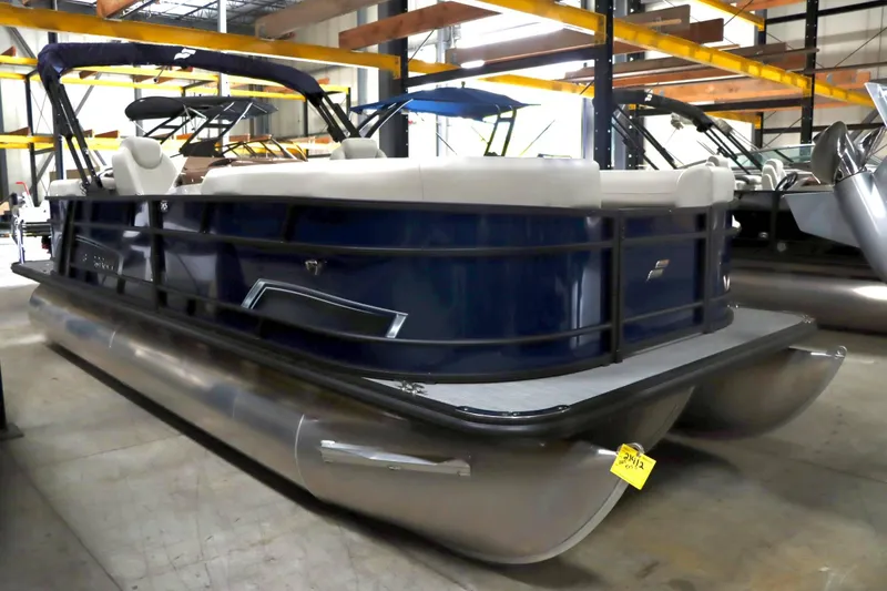 Slide: The Image of 2025 Starcraft EXS 3 pontoon boat in showroom, featuring sleek design and modern seating. - 3