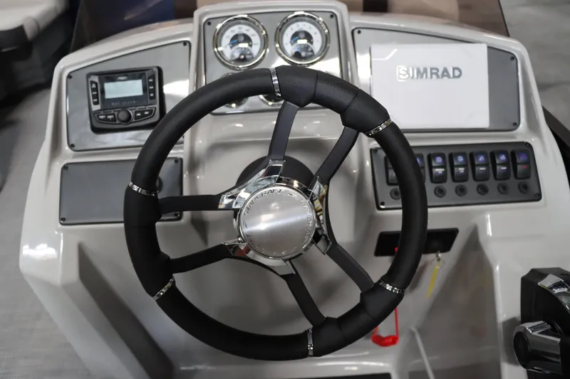 Slide: The Image of 2025 Starcraft EXS 3 boat dashboard with steering wheel and control panel. - 19