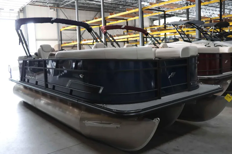 Slide: The Image of 2025 Starcraft EXS 3 pontoon boat in warehouse, side view. - 4