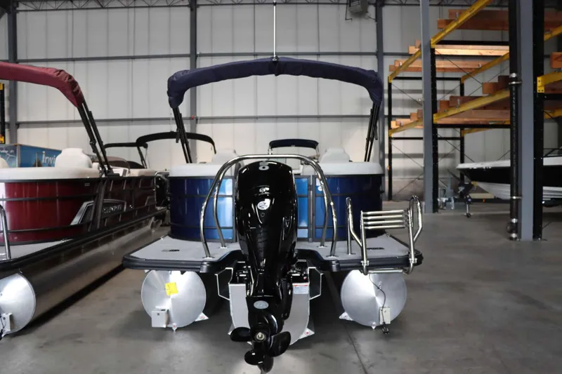 Slide: The Image of 2025 Starcraft EXS 3 pontoon boat in warehouse, rear view with motor. - 5