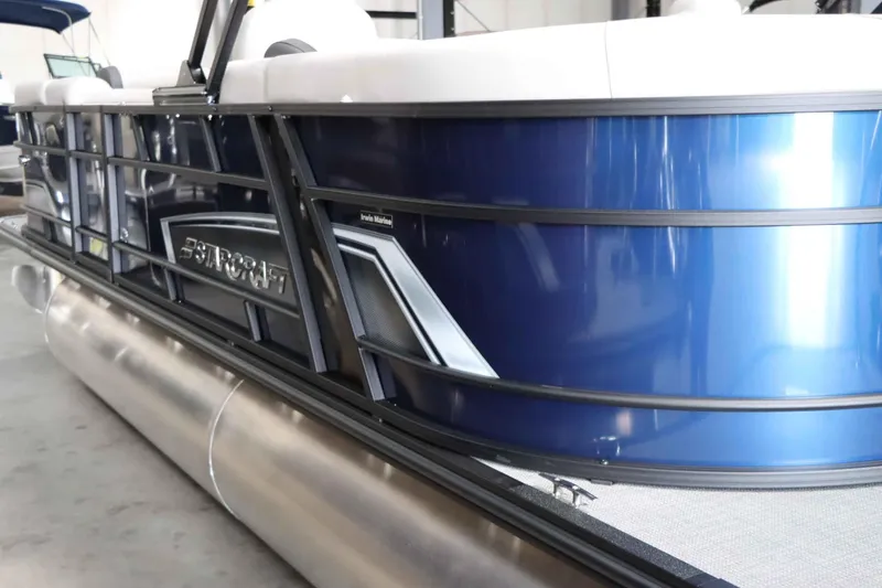 Slide: The Image of 2025 Starcraft EXS 3 pontoon boat with sleek blue exterior design. - 6