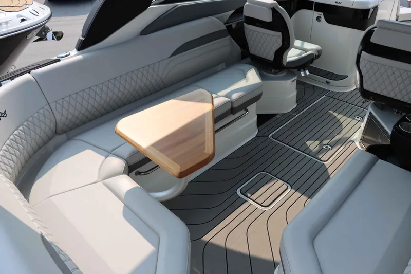Slide: The Image of Luxurious interior of 2024 Sea Ray 280SLX boat with elegant seating and wooden table. - 10