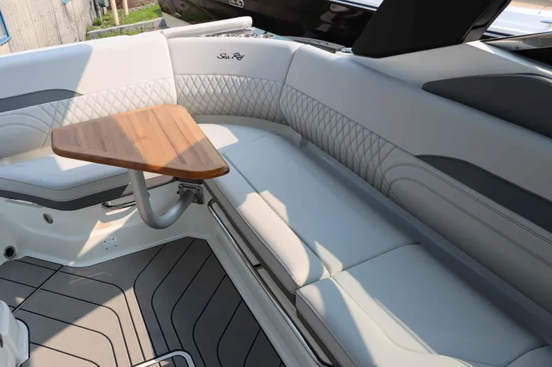 Slide: The Image of Luxurious seating area on 2024 Sea Ray 280SLX boat with elegant wooden table. - 11