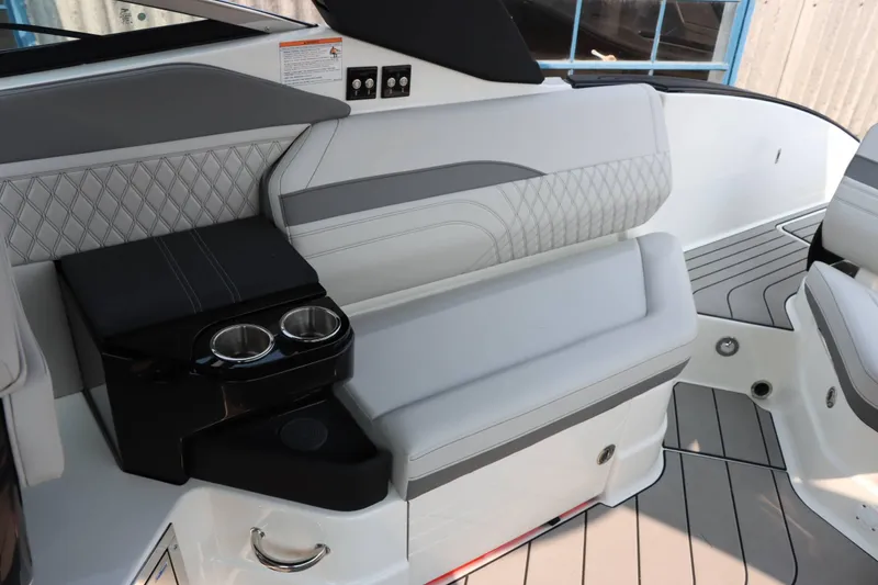 Slide: The Image of 2024 Sea Ray 280SLX boat interior with luxurious seating and cup holders. - 12