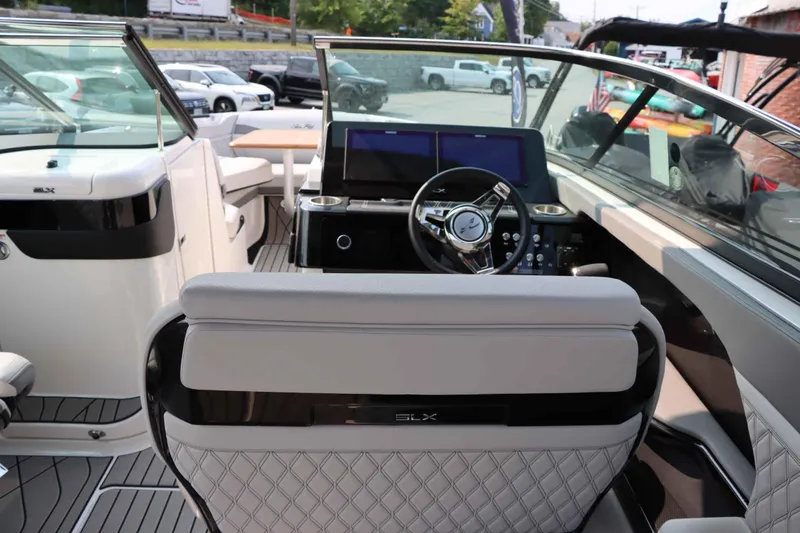 Slide: The Image of 2024 Sea Ray 280SLX boat interior with modern dashboard and seating. - 14