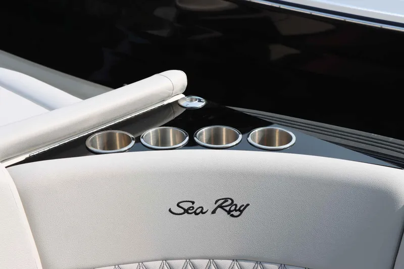 Slide: The Image of 2024 Sea Ray 280SLX boat interior with cup holders and logo. - 16