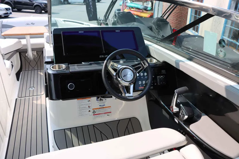 Slide: The Image of 2024 Sea Ray 280SLX boat interior with modern dashboard and steering wheel. - 18