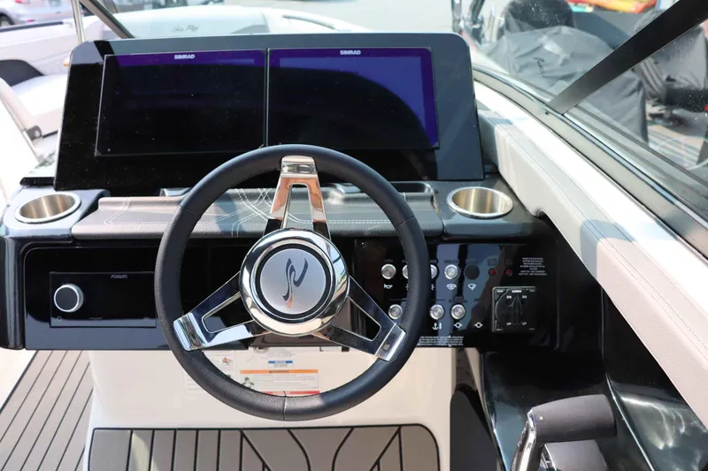 Slide: The Image of 2024 Sea Ray 280SLX boat dashboard with steering wheel and dual Simrad displays. - 21