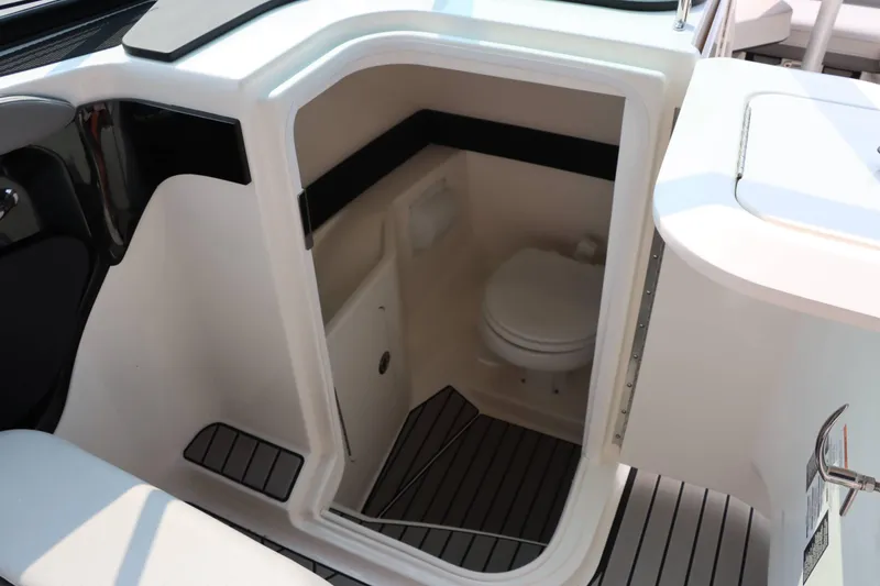 Slide: The Image of 2024 Sea Ray 280SLX boat interior with compact bathroom and toilet. - 24