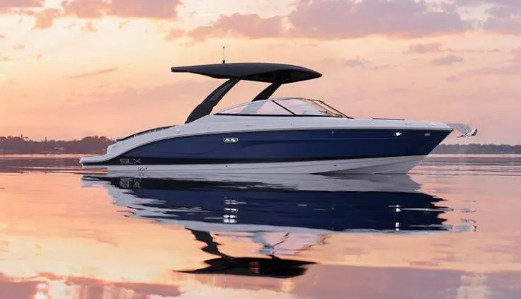 Slide: The Image of 2024 Sea Ray 280SLX boat on calm water at sunset. - 26