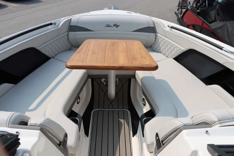 Slide: The Image of 2024 Sea Ray 280SLX boat interior with elegant seating and wooden table. - 27