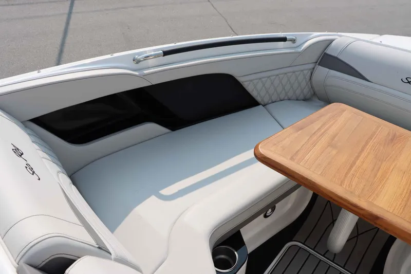 Slide: The Image of Luxurious seating area on 2024 Sea Ray 280SLX boat with wooden table. - 28