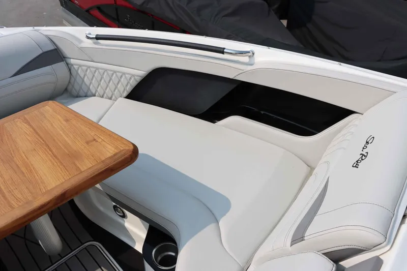Slide: The Image of Luxurious interior of 2024 Sea Ray 280SLX boat with wooden table and plush seating. - 29