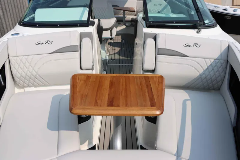 Slide: The Image of 2024 Sea Ray 280SLX boat interior with elegant seating and wooden table. - 31