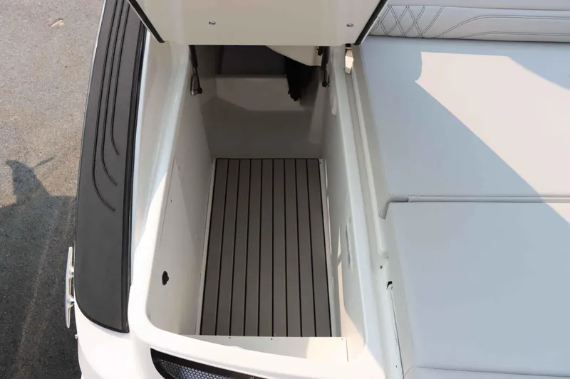 Slide: The Image of 2024 Sea Ray 280SLX boat storage compartment with open lid. - 34