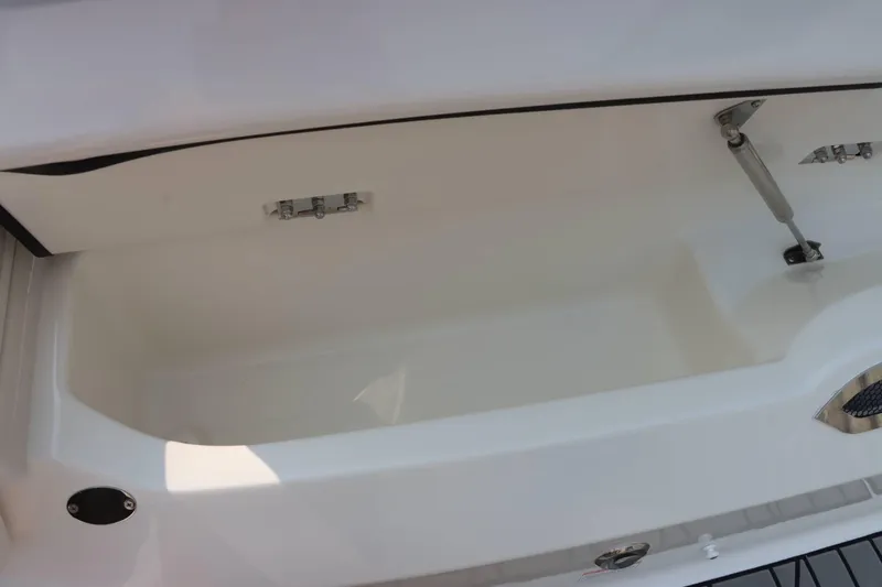 Slide: The Image of 2024 Sea Ray 280SLX storage compartment with open lid and hydraulic support. - 35