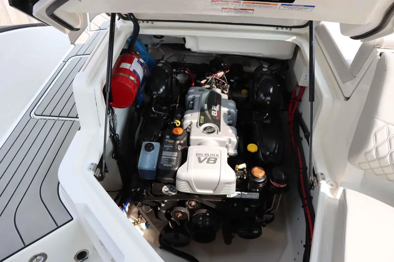 Slide: The Image of 2024 Sea Ray 280SLX engine compartment with V8 engine and fire extinguisher. - 36