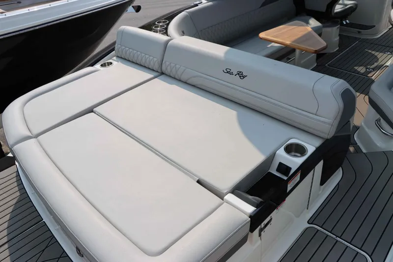 Slide: The Image of 2024 Sea Ray 280SLX boat interior with luxurious seating and cup holders. - 6