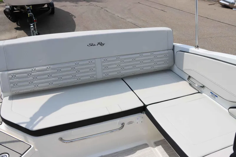 Slide: The Image of 2025 Sea Ray 210SPX boat interior seating, featuring sleek white upholstery and modern design. - 11