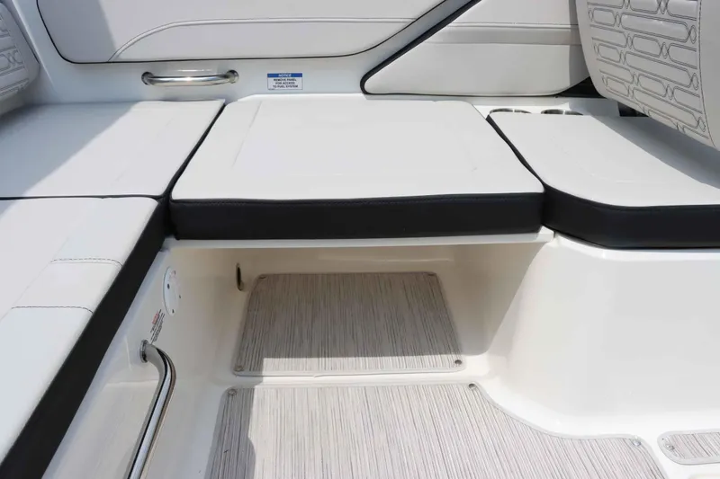 Slide: The Image of Interior seating of 2025 Sea Ray 210SPX boat, featuring sleek white and black upholstery. - 12