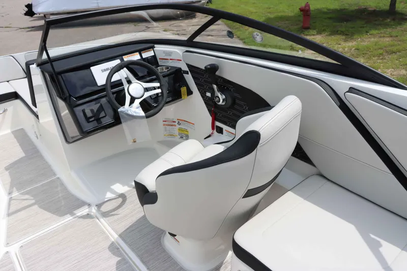 Slide: The Image of 2025 Sea Ray 210SPX boat interior with modern steering and seating. - 15