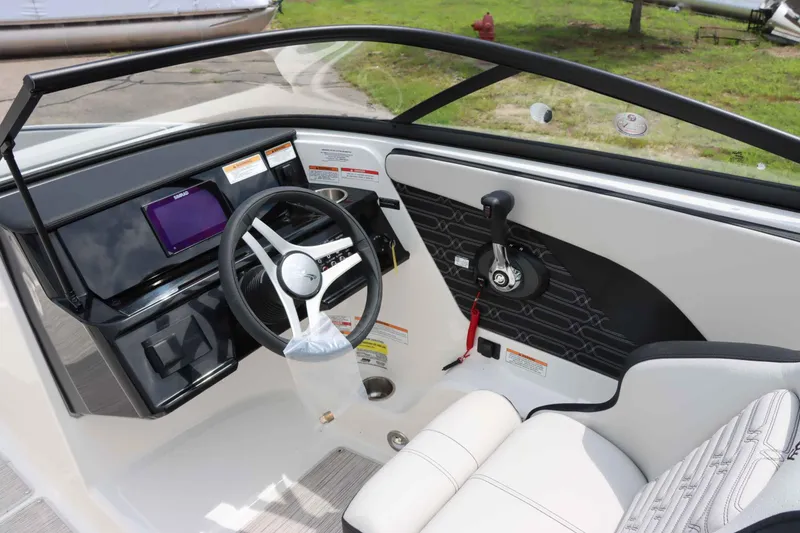 Slide: The Image of 2025 Sea Ray 210SPX boat interior with steering wheel and control panel. - 16