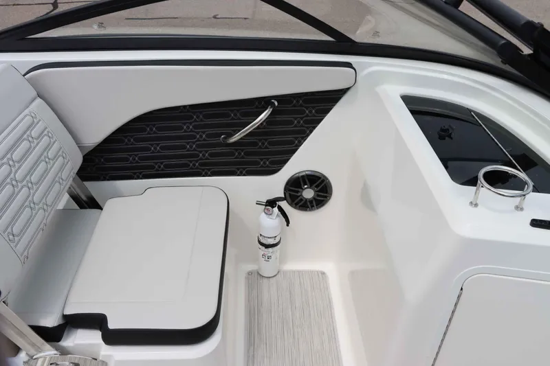 Slide: The Image of 2025 Sea Ray 210SPX boat interior with seating, speaker, and fire extinguisher. - 18