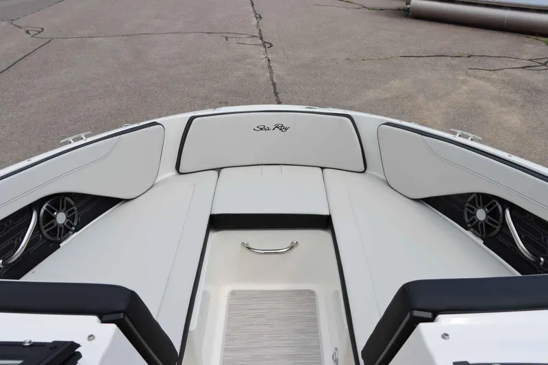 Slide: The Image of 2025 Sea Ray 210SPX boat interior with white seating and speakers. - 20
