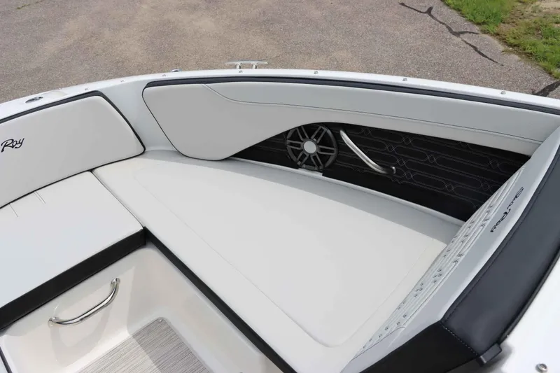 Slide: The Image of 2025 Sea Ray 210SPX boat interior with white seating and speaker detail. - 21