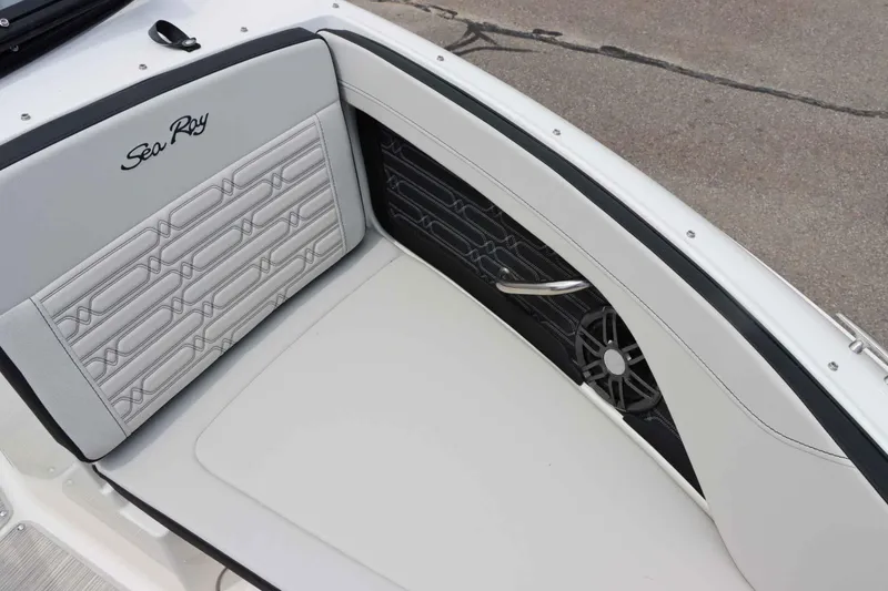 Slide: The Image of 2025 Sea Ray 210SPX boat interior with stylish seating and speaker detail. - 22