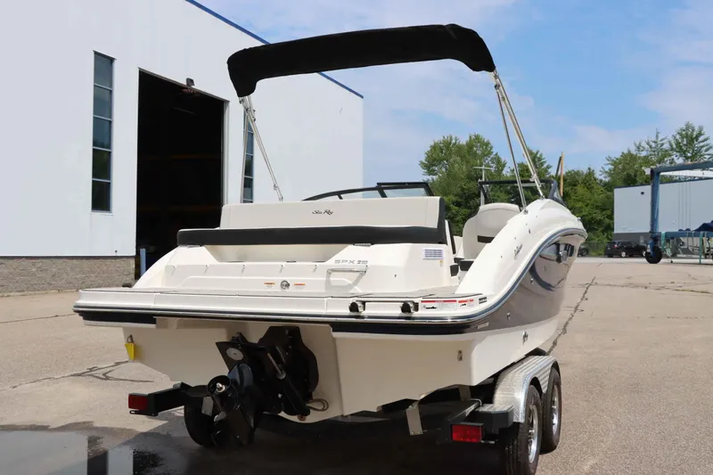 Slide: The Image of 2025 Sea Ray 210SPX boat on trailer, parked outside a building. - 3