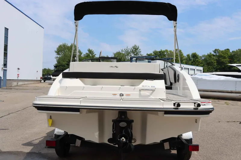 Slide: The Image of 2025 Sea Ray 210SPX boat, rear view, parked outdoors. - 4